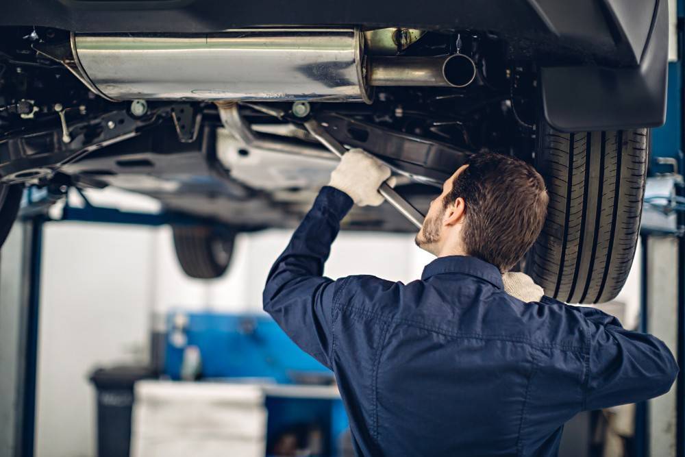 A mechanic checking underneath of the car